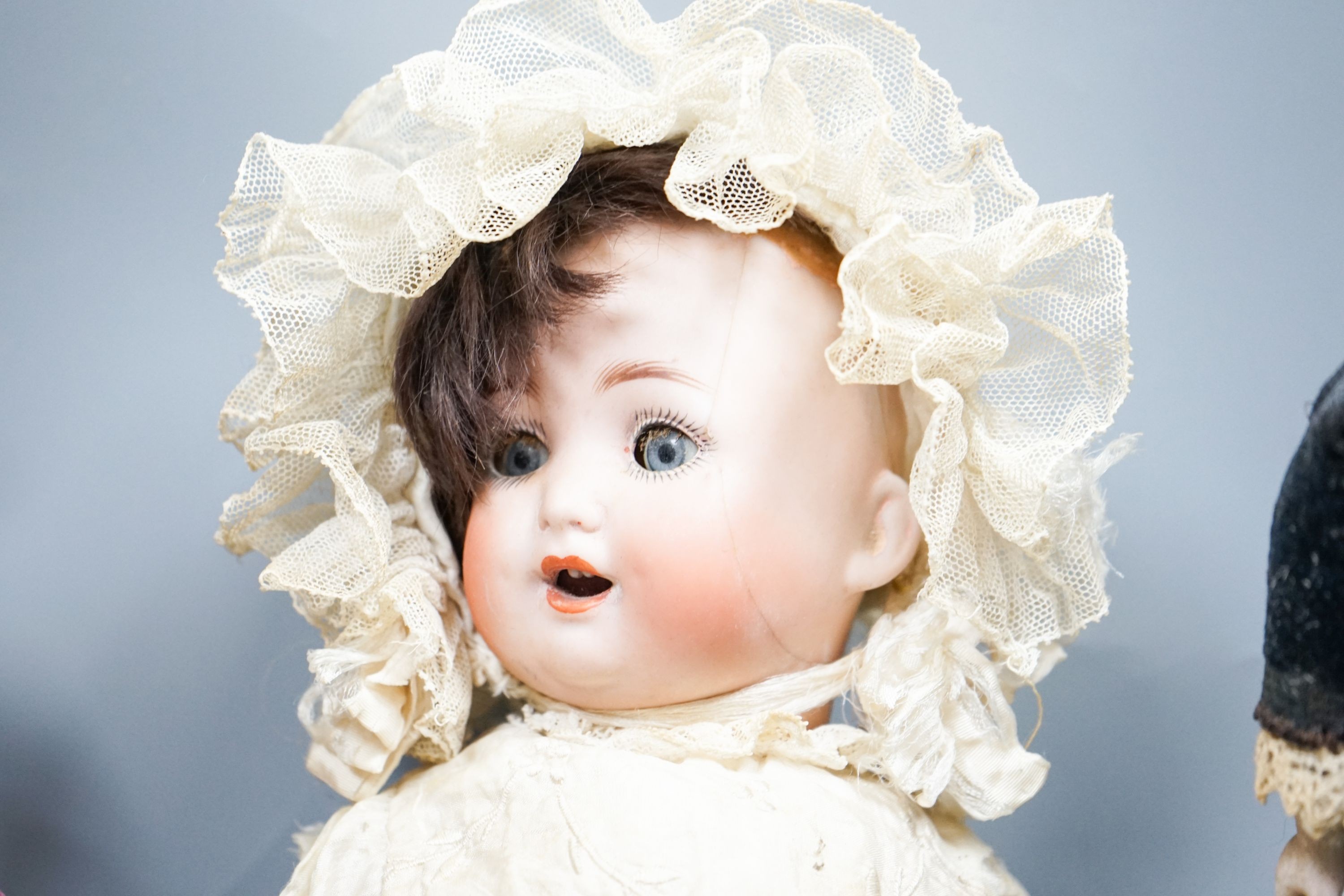 A German bent limb face cracked H12in. German bent limb character baby H9in. bisque head Scottish doll with bisque shoes and hands H10in.